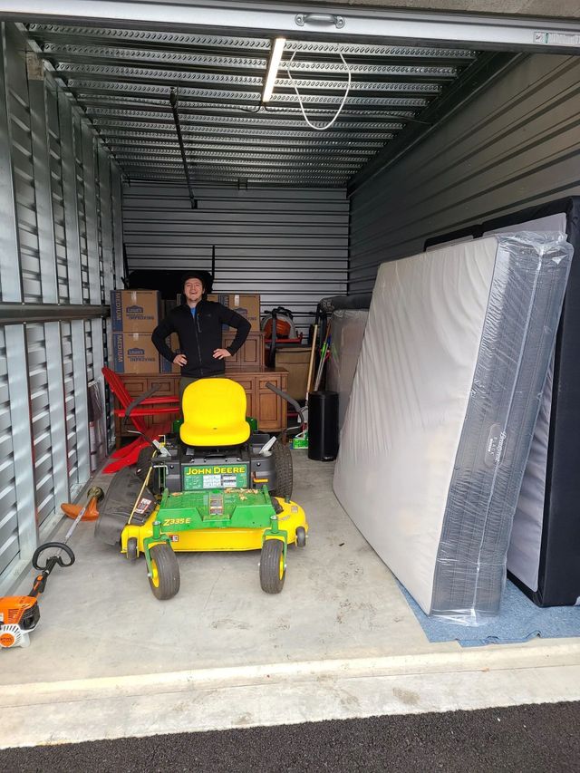 Moving crew organizing appliances and household belongings inside a truck