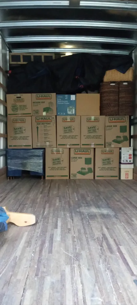 Labeled cardboard boxes organized inside a moving truck