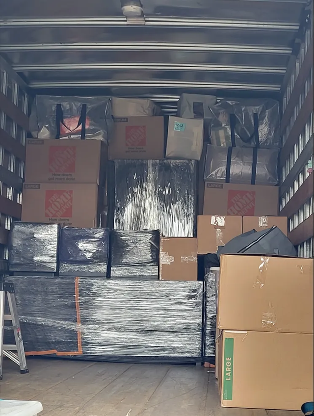 Blanket-wrapped furniture arranged for transport