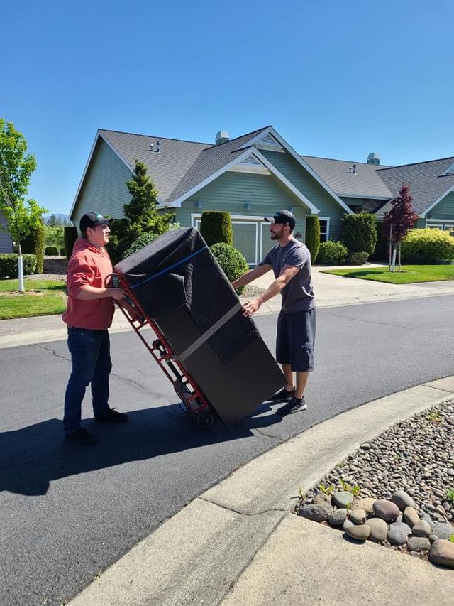 Two movers carrying a protected item from a home
