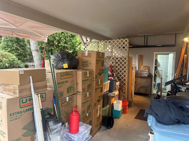 Packed belongings and moving boxes staged on a covered porch