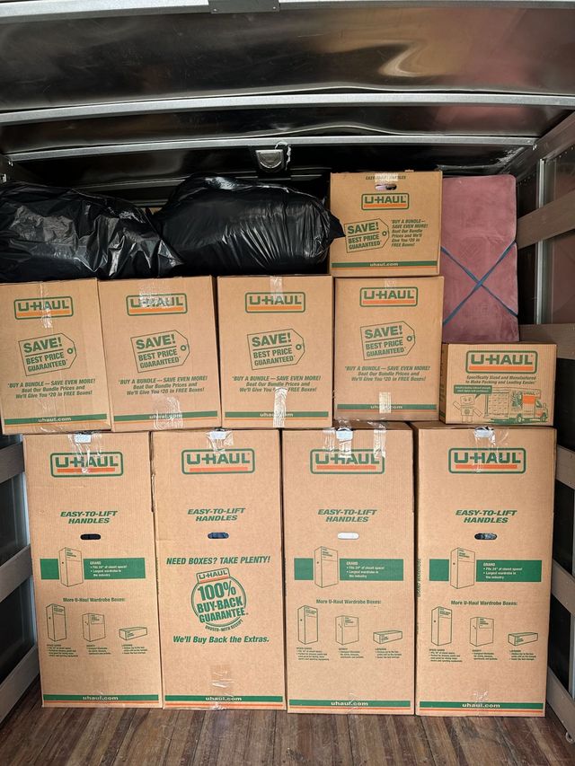 Labeled household boxes stacked inside a moving truck