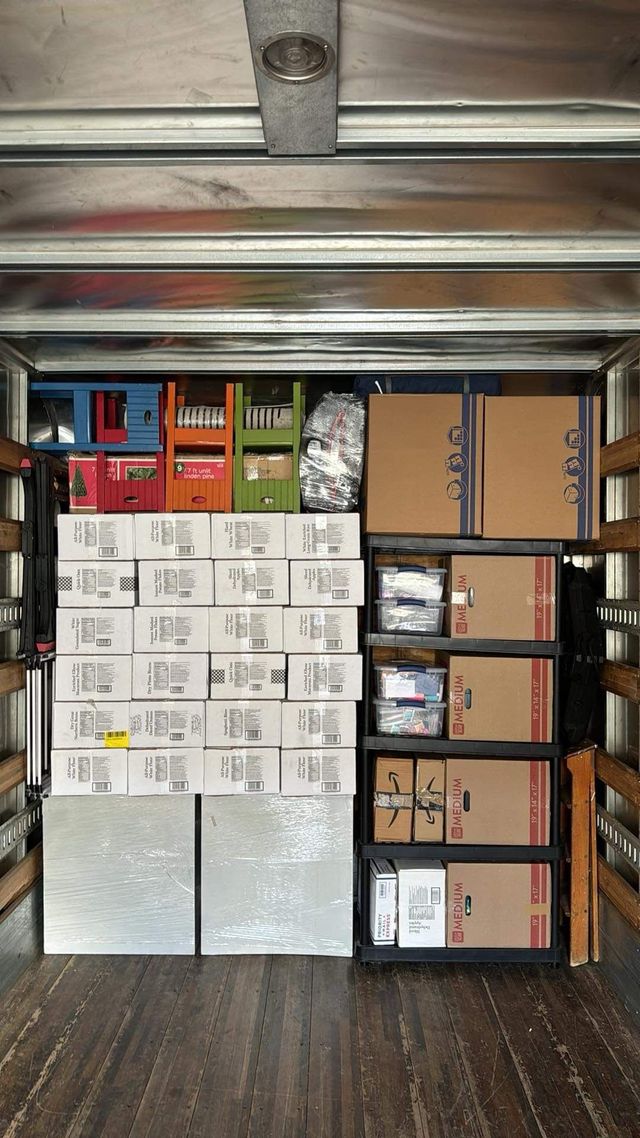 Boxes carefully arranged in rows inside a moving truck
