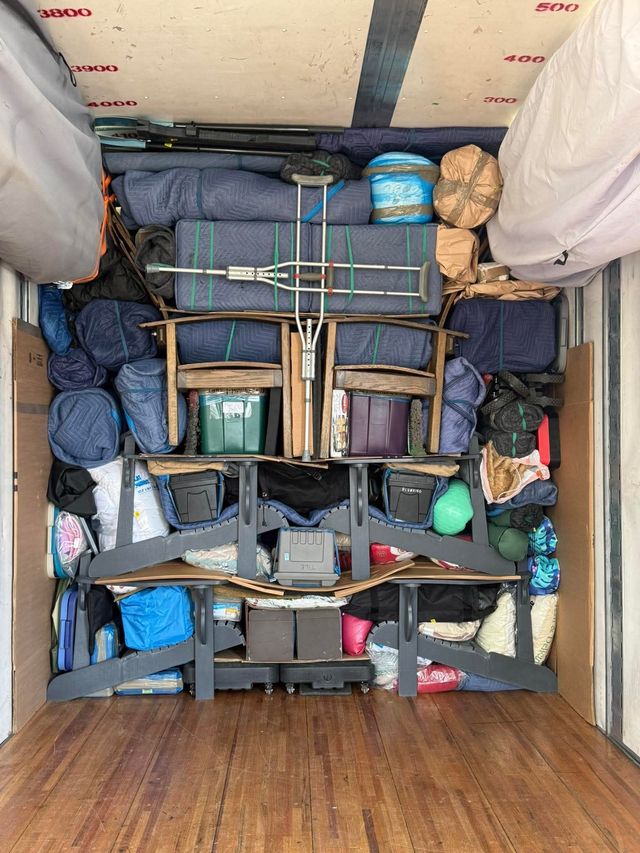 Protected furniture and boxes arranged inside a moving truck
